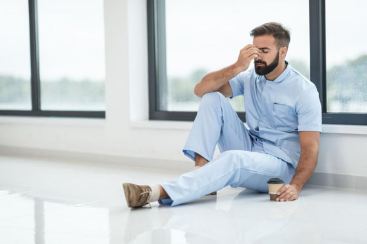 healthcare worker who is tired and who needs good, supportive, non stinky, durable socks, man with stinky feet, doctor with stinky feet, nurse with stinky feet, doctor with foot pain, nurse with foot pain